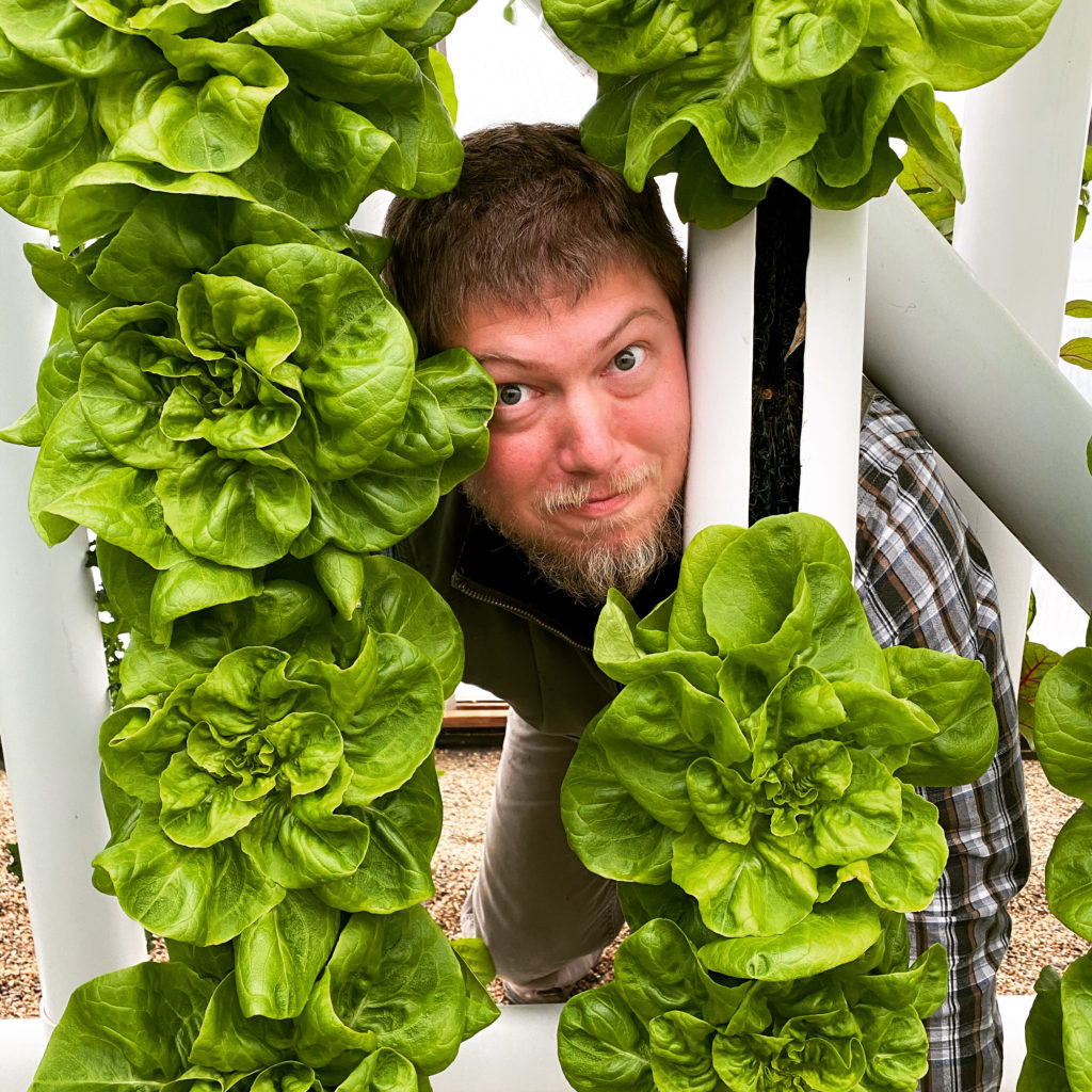 Adam Bunker  at work in vertical hydroponics greenhouse